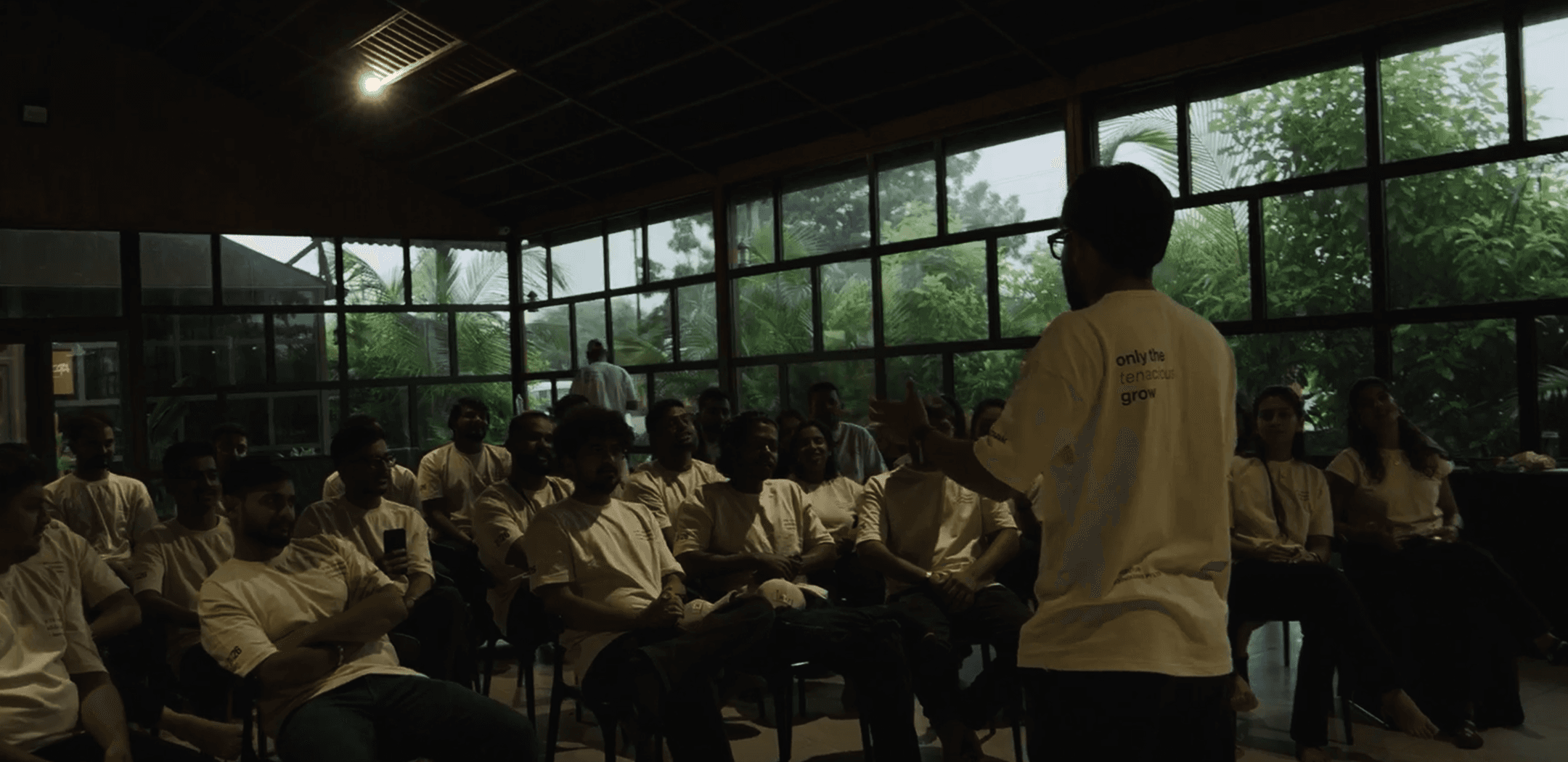 The Techiebutler team gathered for an all-hands talk at the Rajkot studio, wearing shirts reading 'only the tenacious grow'